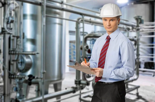 Portrait of smiling confident construction worker wearing hard hat