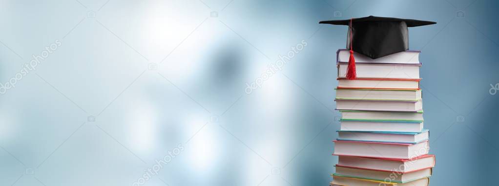 Graduation hat and stack of books