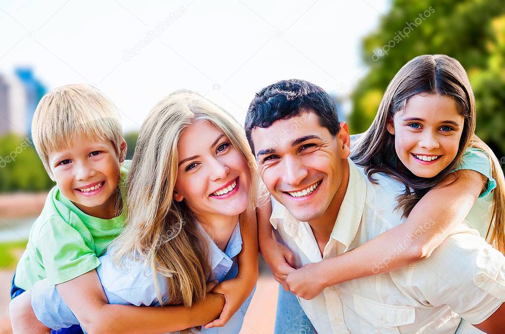 Lovely family hugging in park outdoor  