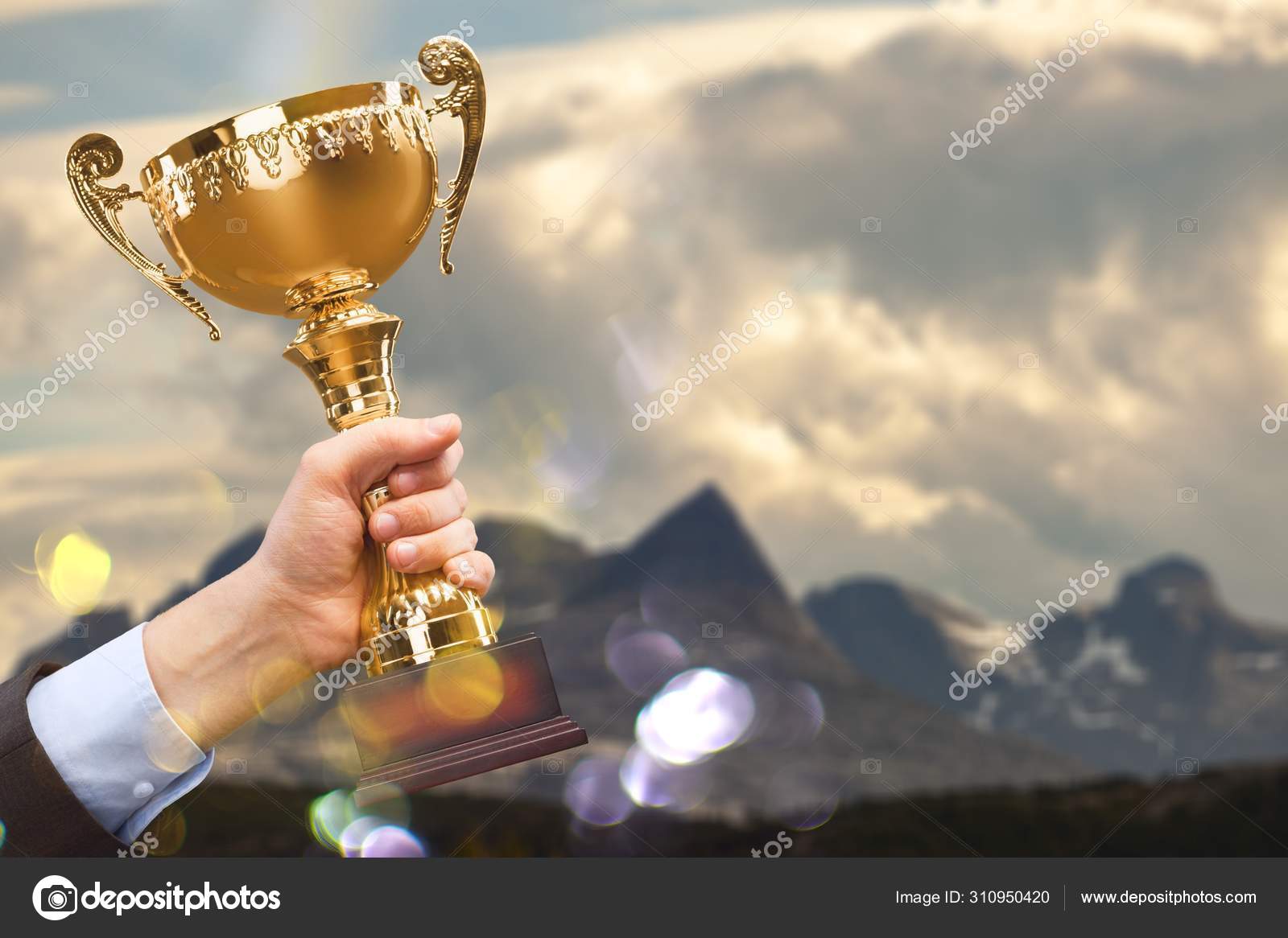 Hands Holding Golden Trophy Background Stock Photo by ©billiondigital  310950420