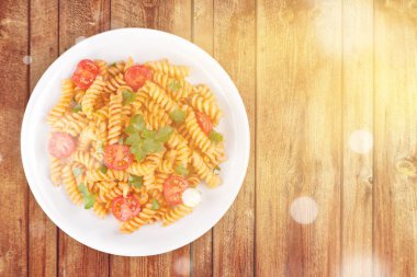 Tahta masada kiraz domatesli spagetti.