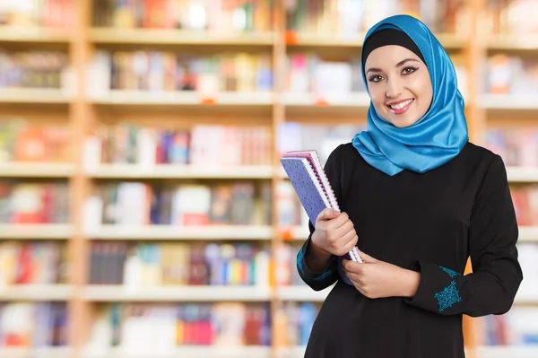 Beautiful young arab woman with notebooks