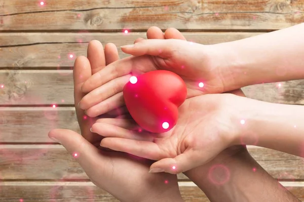 Male Female Hands Holding Heart Wooden Background — Stock Photo, Image