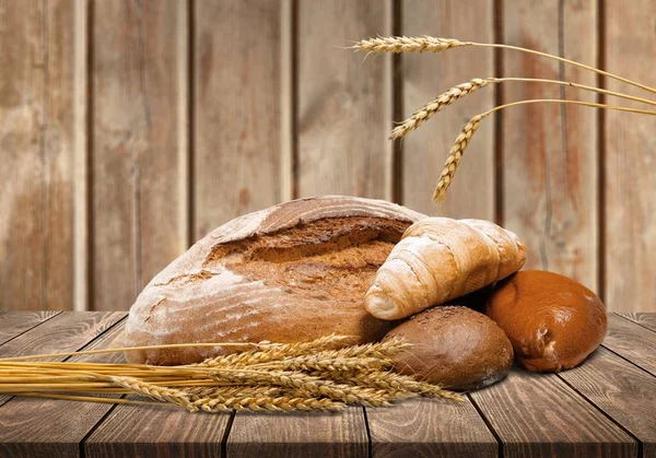 loaves of freshly baked bread on wooden background