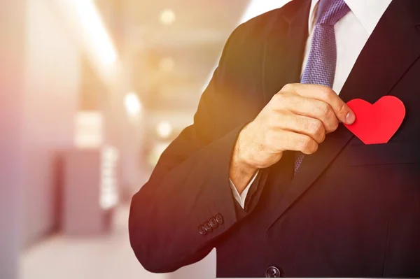 young man in suit with heart in the pocket