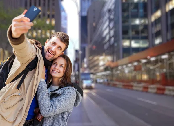happy young couple in the city making selfie