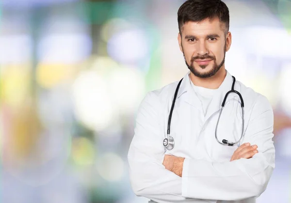 Young doctor with stethoscope on background