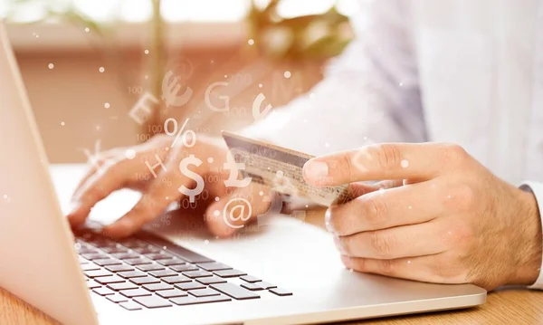 hands of man typing on laptop