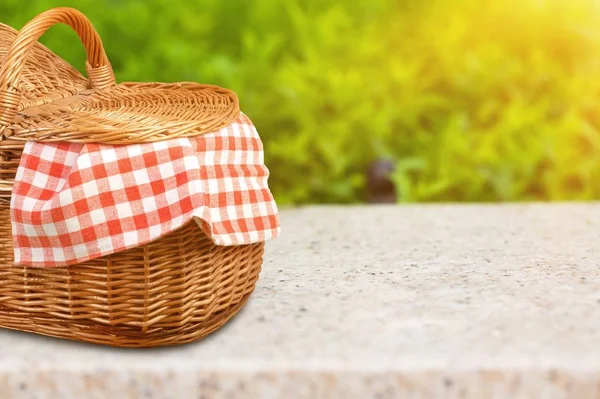 picnic wicker basket on wooden table