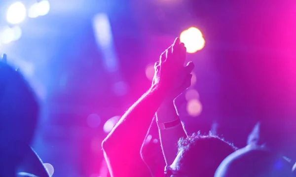 hands of people on colorful bokeh background