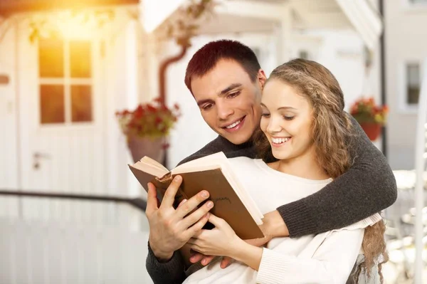 happy young couple with a book