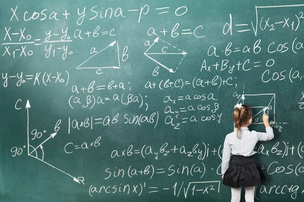 algebra background, little girl writing calculations on blackboard