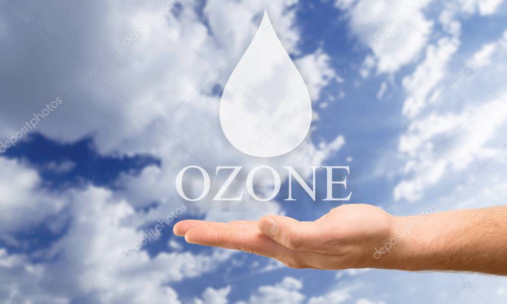  water in woman hand and drop on blue sky background, ozone concept