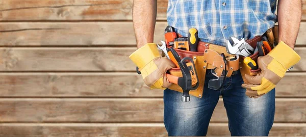 Young man worker with tool belt