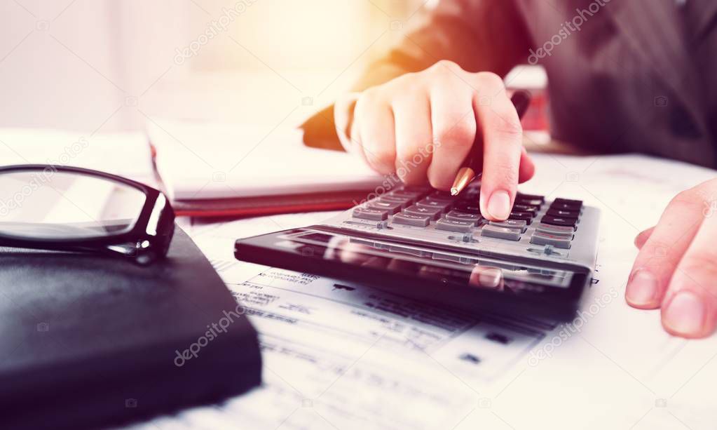 Accountant man with calculator and documents