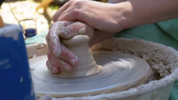 Potters hands work with clay on a potters wheel — Stock Video