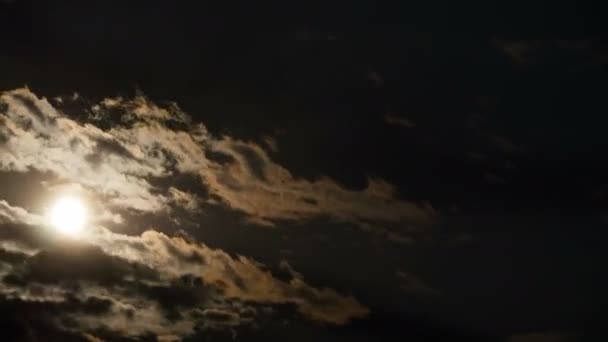 Full Moon Moves in the Night Sky through Dark Clouds and Trees. Time lapse. — Stock Video