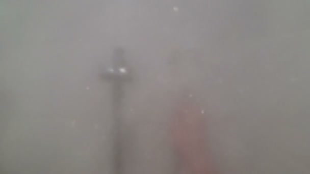 A stream of water from the shower hose is directed into the face, POV — Stock Video