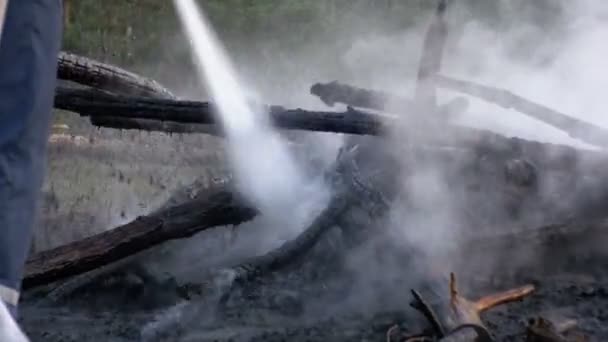 Löschen Sie einen Brand mit Wasser mit einem Feuerwehrschlauch — Stockvideo