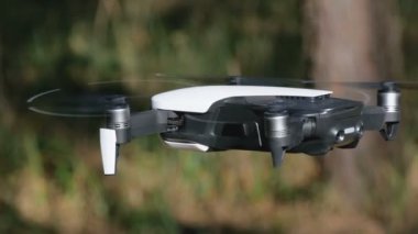 İle robot bir kamera havada uçuşu. Ormandaki yerden quadcopter uçar