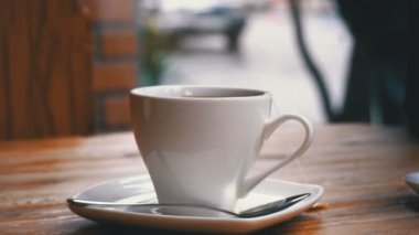 Beyaz fincan çay bir Cafe Cadde penceresinin arka plan üzerinde tablo