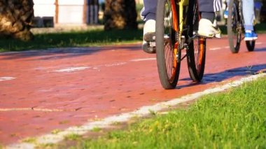 İnsanlar bir 3 tekerlekli elektrikli bisiklet yolu Park üzerinde sürme. Ağır çekim