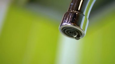 Water Dripping from the Tap into a Sink. Slow Motion