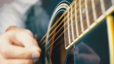 Adam bir arabulucu ile bir akustik gitar çalmak