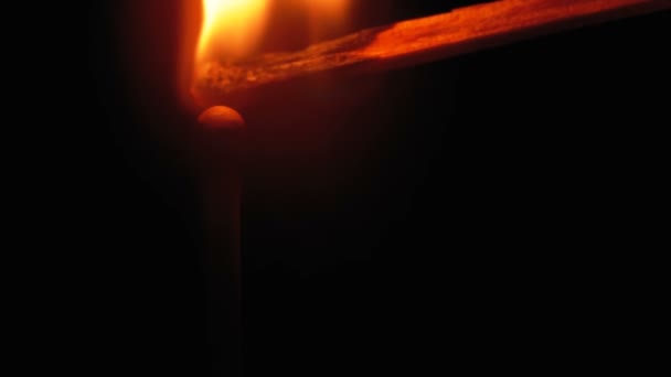 Igniting Match and Flame on a Black Background. Movimento lento — Vídeo de Stock