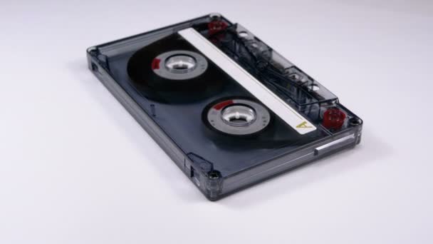 Vintage Transparent Audio Cassette Rotates on White Background — Stock Video