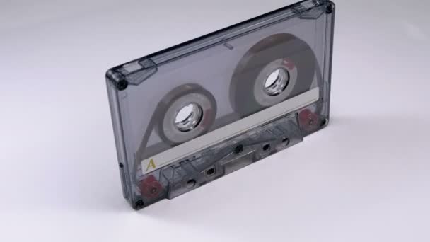 Transparent Audio Cassette Rotates on White Background — Stock Video