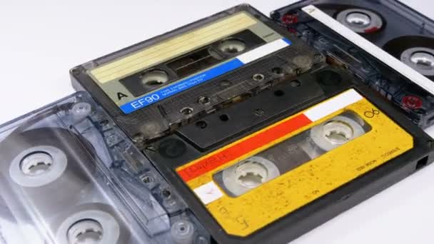 Vier Audiokassetten rotieren auf weißem Hintergrund — Stockvideo
