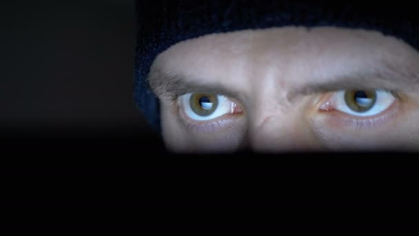 男性黑客在帽子工作的笔记本电脑显示器在夜间 — 图库视频影像