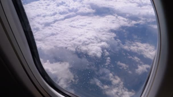 View from the Window of the Plane at the Clouds. Airplane flies above the weather — Stock Video