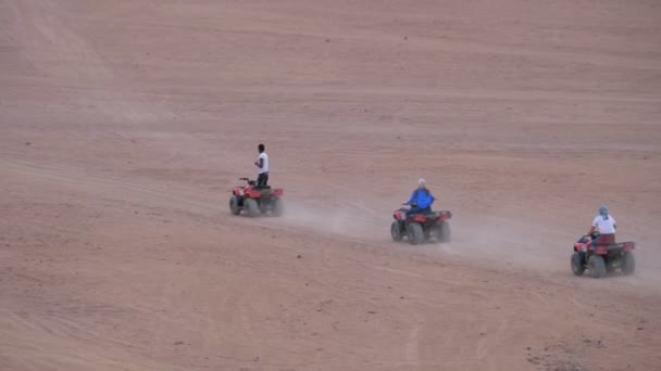 Group on Quad Bike Rides through the Desert in Egypt Driving ATVs. — Stock Video