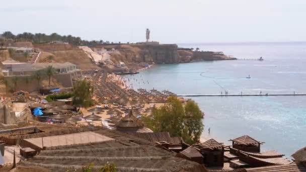 Plaża w luksusowym hotelu z parasolami i leżakami na Morzu Czerwonym w pobliżu rafy koralowej. Egipt — Wideo stockowe