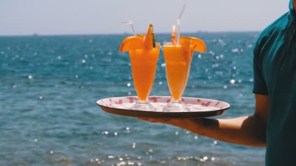 Exotic Cocktails in a Glass with a Straw on a Tray on the Background of the Sea. Egypt. — Stock Video