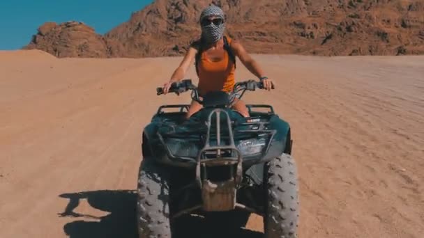 Sexy Girl on a Quad Bike Rides through the Desert of Egypt on Background of Mountains — Stock Video