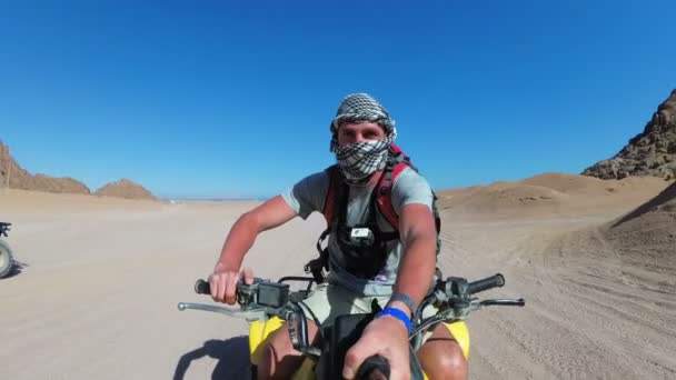 Man is Riding a Quad Bike in Desert of Egypt and Shooting Himself on an Action Camera — Stock Video