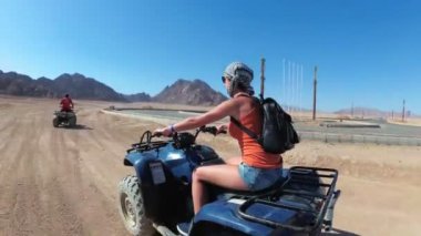 Seksi Kadın Mısır Çölü'nde bir Dört Bisiklet Sürme olduğunu. Hareket halindedinamik görünüm.