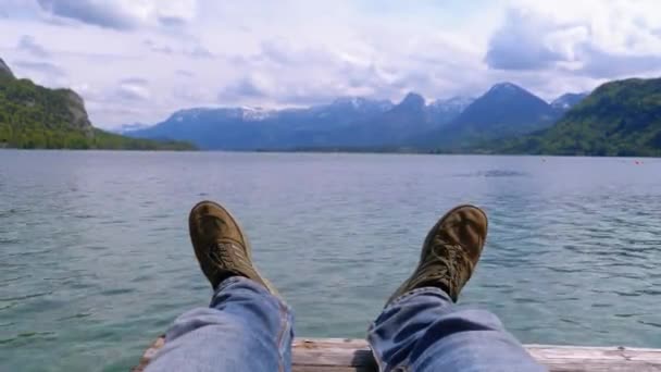 Human Legs on the Background of a Mountain Lake and Snow-covered Mountains. — Stock Video