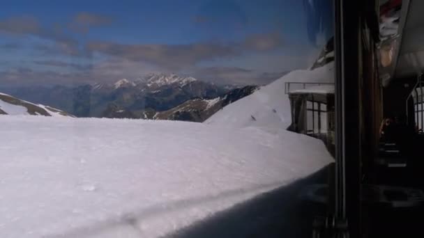 Narrow Gauge Cogwheel Tourist Train Rides in the Snowy Mountains. Switzerland, Alps — Stock Video