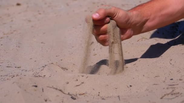 Sand Falls from a Man s Hand on the Beach in Slow Motion. Dirty sand in hand of men — Stock Video