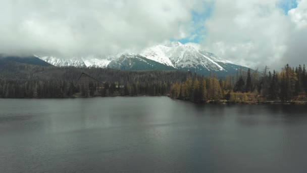 Aerial view of Strbske Pleso in the Clouds and Snowy Mountains. Slovakia — Stock Video