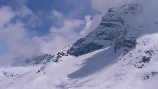 Landscape view of Alpine Mountain Snowy Peak in the Clouds. Simplon Pass. — Stock Video