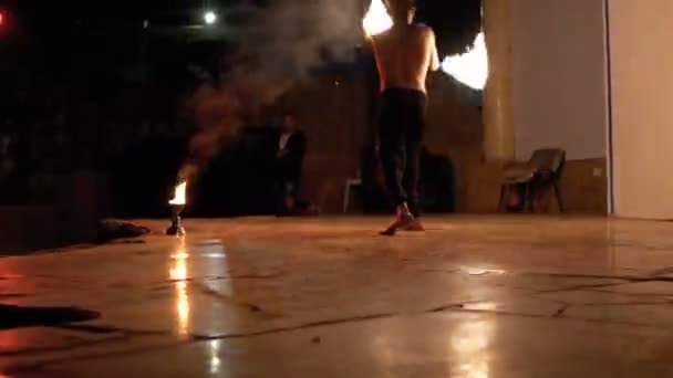 Fire Show Performance on Stage. Young Man Dancing with Fiery Fans on a Night Show — Stock Video
