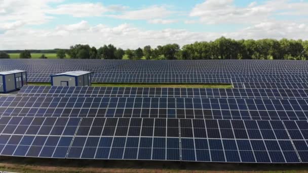 Vista aérea de la Central Solar. Paneles de pie en una fila en el campo verde. Verano — Vídeos de Stock