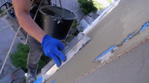Industrial Climber menggunakan Trowel Putty Glue pada Fiberglass Mesh to Insulate Facade — Stok Video