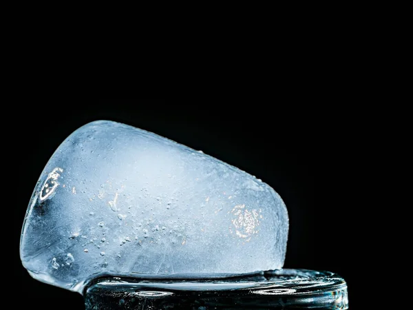 Ice Melts and Rotates on a Black Background. — Stock Photo, Image