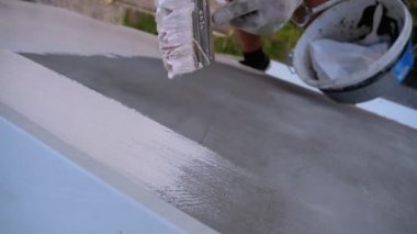 Endüstriyel dağcı boya fırçasıyla duvarları beyaz boyayla boyuyor. Yavaş Hareket
